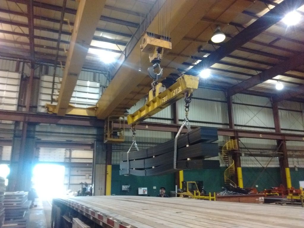 crane at Olympic Steel loading flat steel on to a flatbed trailer crane at Olympic Steel loading flat steel on to a flatbed trailer