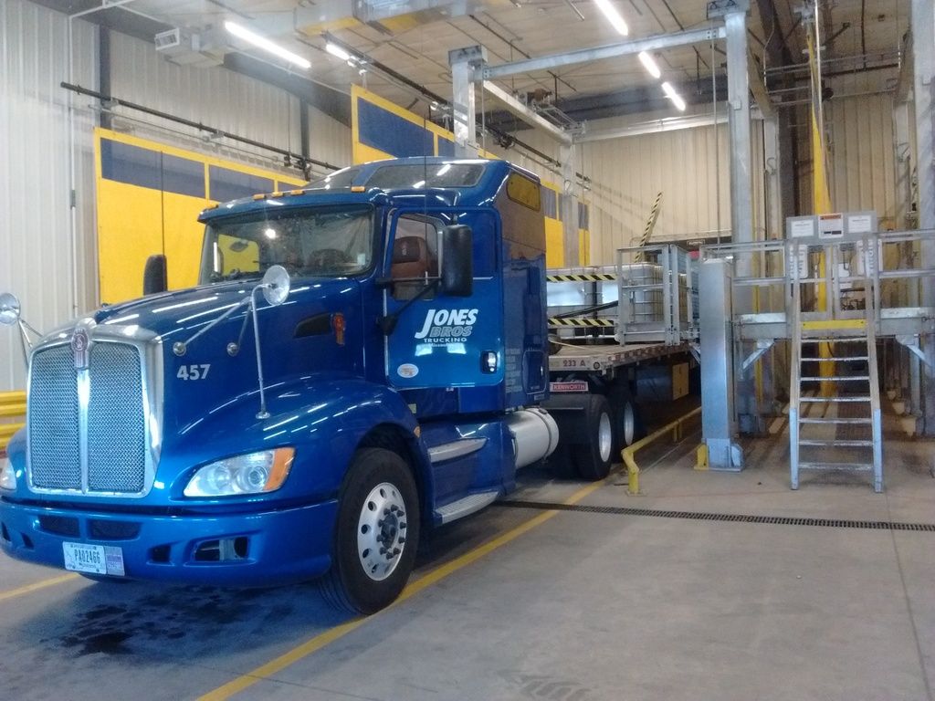 flatbed trailer in warehouse loaded with barrels of paint flatbed trailer in warehouse loaded with barrels of paint
